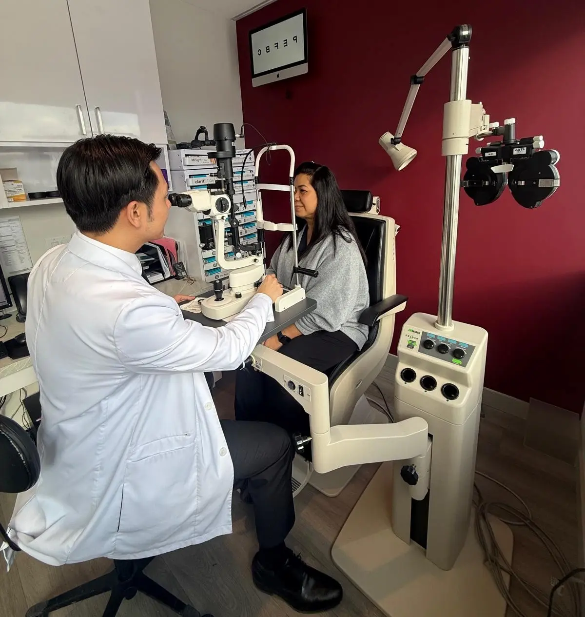 A U Optical optometrist performing a comprehensive eye examination